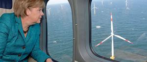 Je größer, desto besser. Das glaubt die Bundesregierung (hier Angela Merkel bei einem Hubschrauberrundflug über die Ostsee) und fördert Riesenwindräder auf See besonders großzügig. Die Branche will aber auch Riesen an Land genehmigt bekommen. Hier gibt es Streit.