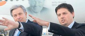 Die Hände zum Himmel. Berlins Regierender Klaus Wowereit (SPD) und Easyjet-Deutschland-Chef Thomas Haagensen vor einem Airbus des Billigfliegers, der mit Willy-Brandt-Konterfei am Rumpf europaweit für Berlins neuen Flughafen BER werben soll.