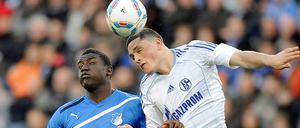 Hoffenheims Peniel Mlapah (l.) und der Schalker Kyriakos Papadopoulos kaempfen um den Ball.
