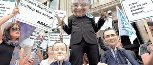 Strippenzieher. Demonstranten protestieren in London gegen Medienzar Rupert Murdoch. Mitarbeiter seines Blatts „News of the World“ sollen Handys ausspioniert haben.