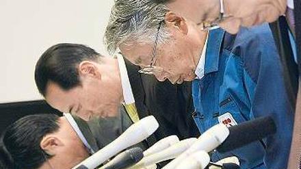 Gesenkte Häupter. Der stellvertretende Vorsitzende von Tepco, Takashi Fujimoto (2. von rechts) verbeugt sich mit anderen Managern während einer Pressekonferenz.