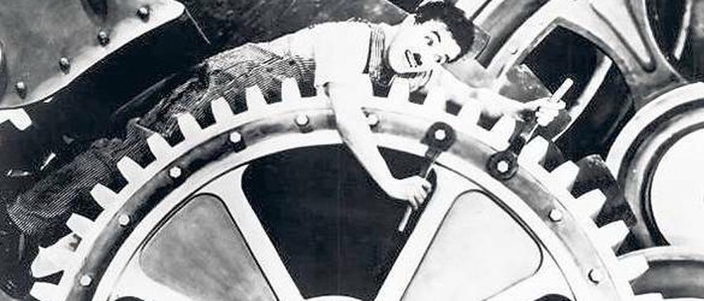 Im Räderwerk. Der Mensch als Knecht der Uhr – persifliert 1936 von Charlie Chaplin in „Moderne Zeiten“. Foto: p-a/Mary Evans Pi