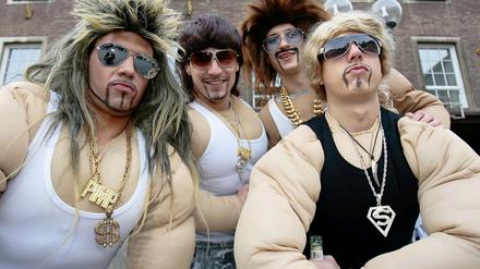 Narren bei der Weiberfastnacht in Düsseldorf spielen Dinosaurier des Testosteron-Zeitalters.