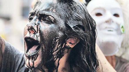 Langsam wird das Ausmaß der Katastrophe bewusst. Demonstranten protestieren in Manhattan gegen BP. Fotos: Getty Images/AFP(2)