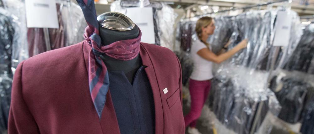 Bahn-Mitarbeiter bekommen neue Uniformen in Weinrot und Blau.