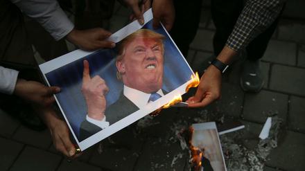Iranische Demonstranten verbrennen in Teheran ein Bild des US-amerikanischen Präsidenten Trump vor der früheren US-Botschaft.