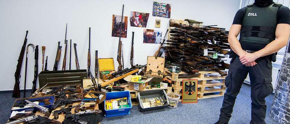 Ein Zollbeamter vor einem Waffenarsenal in einem Haus in Schwerte. Ein 54-Jähriger betrieb unerlaubten Handel. 