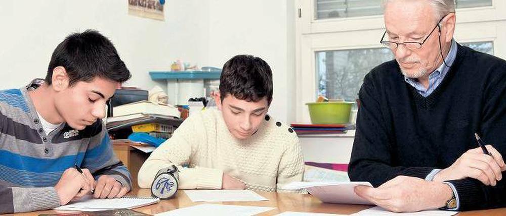 Gemeinsam geht’s besser. Die Schüler Emil (li.) und Enes lernen mit ihrem Lesepaten Dieter Zündel an der Hermann- von-Helmholtz-Schule in Gropiusstadt.