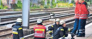Unglücksort. Die Feuerwehr an der Unfallstelle. Wie das Unglück passieren konnte, ist unklar. Eigentlich muss die Zugtür sich öffnen, wenn jemand eingeklemmt ist. Foto: Andreas Meyer