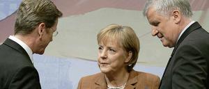 Westerwelle (l.), Merkel und Seehofer.