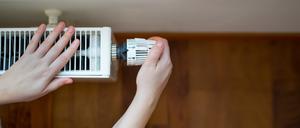 Hand of young woman changing the temperature on the radiator by temperature controller