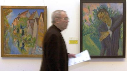 Ein Besucher geht am Donnerstag (15.01.2004) im Berliner Brücke-Museum an den den Gemälden"Roquairol" (1917, r) und "Tübingen" (1920) von Erich Heckel vorbei. Die Gemälde sind zwei der acht im Jahre 2002 gestohlenen Meisterwerke deutscher Expressionisten, die jedoch später wieder gefunden worden waren. Nach fast zwei Jahren kehren sie im Anschluss an eine Restaurierung an ihren Stammplatz zurück. 
