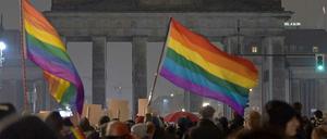 Gegendemonstranten vor dem dunklen Brandenburger Tor.