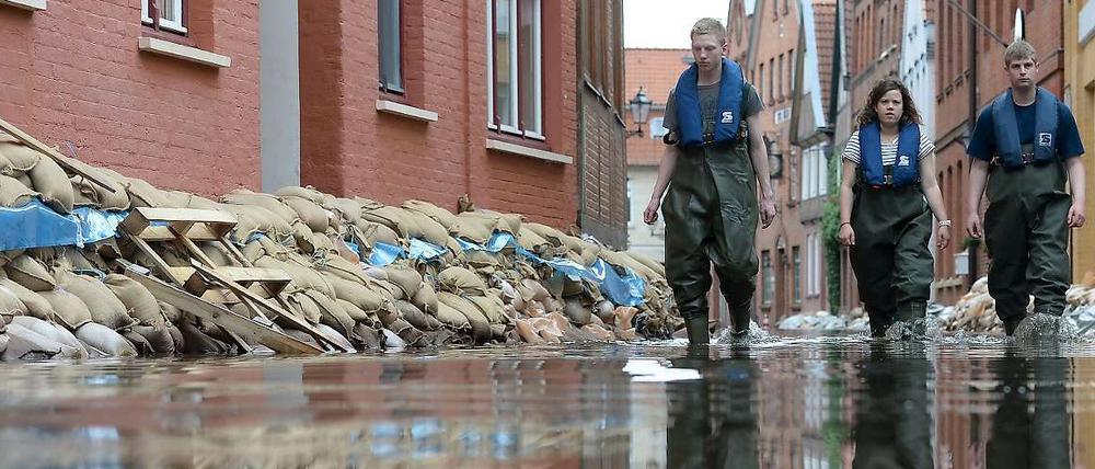 Unterstadt unter Wasser. Mitarbeiter des Technischen Hilfswerks bahnen sich ihren Weg durchs die Fluten im schleswig-holsteinischen Lauenburg. In der Nacht zum Donnerstag ist der Pegelstand der Elbe dort etwas gesunken. 