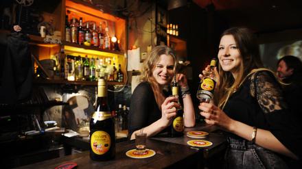Zwei junge Frauen trinken "Mampe halb und halb" in der 8MM Bar am Senefelderplatz.