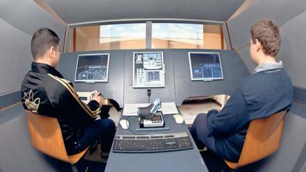 Neuntklässler der Alfred-Nobel-Schule im Cockpit des Flugsimulators.