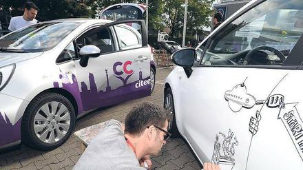 Kunst am Auto. Citee-Car hat keine Ausleihstationen, sondern benutzt die Garagen und Parkplätze seiner Kunden. Wer seinen privaten Stellplatz zur Verfügung stellt, darf günstiger fahren, aber muss das Auto auch selbst pflegen. 