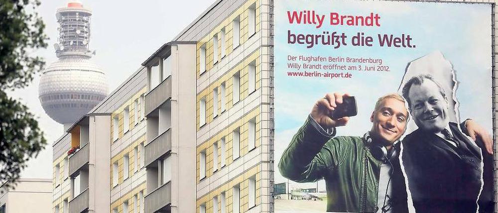 Und sie lächeln und lächeln und lächeln. DJ Paul van Dyk und Willy Brandt sind die Botschafter des Flughafens – und auch die Gesichter der aktuellen Krise.