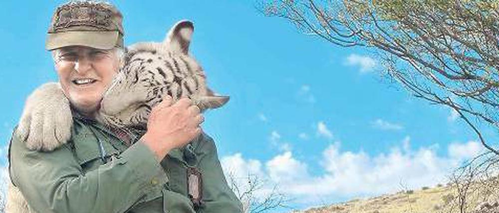 Gefährlich nah. Zärtlich küsst die Raubkatze den Naturschützer John Varty am Hals. Der südafrikanische Tierfilmer hat die Gefahr falsch eingeschätzt. Ein anderer Tiger hat ihn jetzt fast zu Tode gebissen.