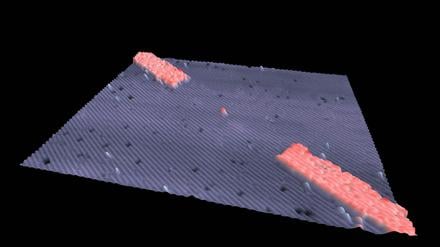 Ein Nanotransistor. Die Mikroskopaufnahme zeigt das Phosphoratom (rot) sowie die elektrischen Kontakte, ebenfalls in Rot. 