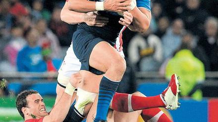 Durchbruch im Eden Park. Der französische Center Maxime Mermoz (mit Ball) entkommt im Halbfinale dem Waliser Jamie Roberts (unten). Foto: AFP