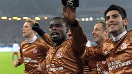 St. Paulis Torschütze Gerald Asamoah (2.v.l) jubelt nach seinem Treffer.
