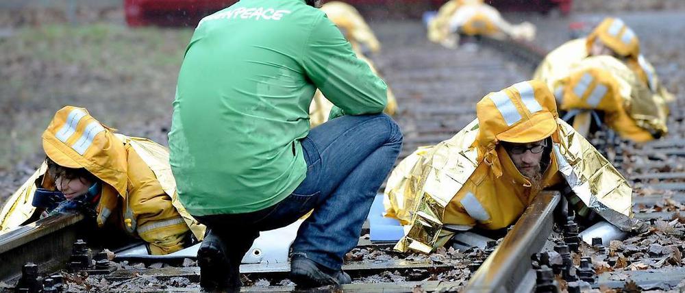 Greenpeace-Aktivisten haben am Dienstagmorgen in Karlsruhe Bahngleise blockiert, um gegen den bevorstehenden Castor-Transport zu protestieren. 