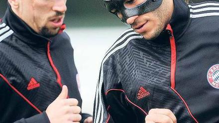 Angeschlagen ins Spiel. Martin Demichelis (r.) demonstriert mit seiner Gesichtsmaske den Zustand des FC Bayern.