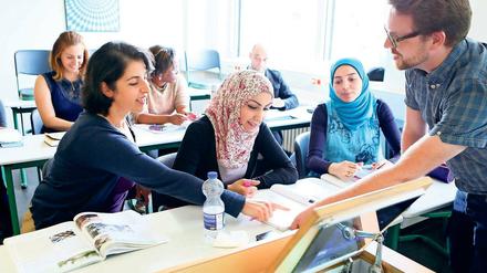 Intensive Vorbereitung. Die Studenten von Marc Deckers (rechts) bereiten sich in seinem Deutschkurs für Geflüchtete auf die Abschlussprüfung im September vor. Alle, die bestehen, werden als Assistenzlehrer an Schulen in ganz Brandenburg arbeiten können.