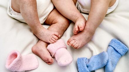 Babys liegen auf einem Bett.