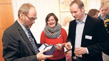 Zum Abschied einen dicken Fisch. Detlef Knuth entdeckt im Geschenkekästchen seine Patenschaftsplakette für den Museumswels. Heimische Fischarten sind Knuths Fachgebiet.