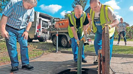 Gut gereinigt. Bernd Zindel (l.) und zwei Monteure der MWA bei der Pumpstation in Güterfelde. Monatlich werden die Pumpen mit Hochdruck sauber gespült, um Verstopfungen vorzubeugen. Bei Müll im Abwasser hilft das aber nicht mehr.