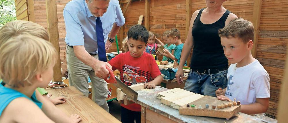 Aufgabenteilung. „Hilfst du mir mal?“, fragte der kleine Junge den Oberbürgermeister, und drückte ihm kurzerhand die Säge in die Hand. So kam es, dass Jann Jakobs auf seiner „Kita-Tour“ nicht nur den Baufortschritt begutachtete, sondern im „Froschkönig“ auch beim Bauen von Puppentischen half.