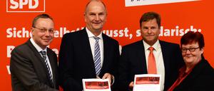 Ein Jahr Rot-Rot in Brandenburg: SPD-Fraktionsvorsitzender Klaus Ness, Ministerpräsident Dietmar Woidke (SPD), der Landesvorsitzende der Linkspartei, Christian Görke und die Fraktionsvorsitzende der Linkspartei, Margitta Mächtig mit dem Koalitionsvertrag in den Händen.
