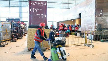 Rollkofferkommando. Vor vier Jahren wurden die Abläufe am BER, wie hier im Terminal, schon mal mit Freiwilligen getestet. Jetzt hat Flughafenchef Mehdorn erneut einen Probebetrieb für die Inbetriebnahme ausgeschrieben.