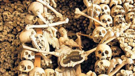 Umgeben von den Resten der Sterblichen. Der Erzengel Gabriel mit seiner Trompete, mit der er am Tag des Jüngsten Gerichts die Toten weckt, in der Knochenkapelle im polnischen Czermna.