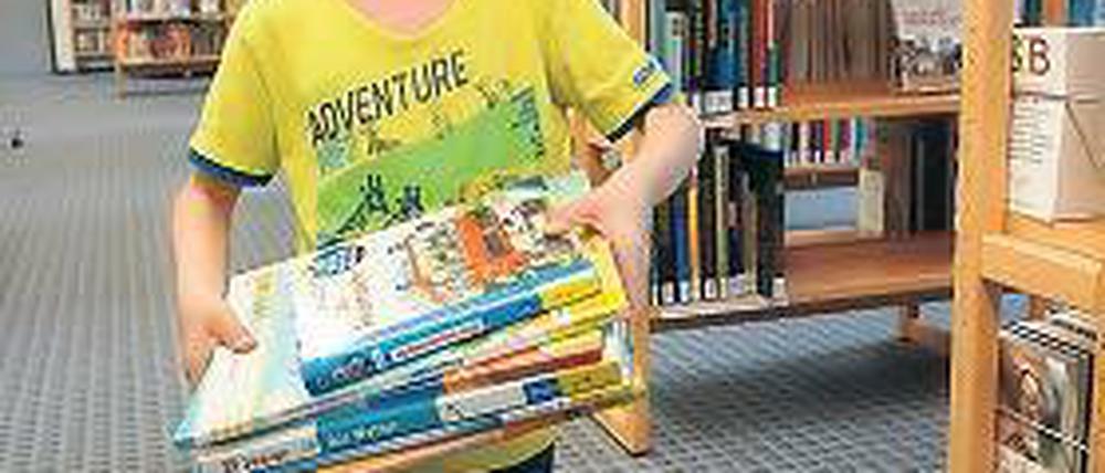 Her mit dem Lesestoff. In den Ferien ist die Bibliothek bei Kindern sehr beliebt.