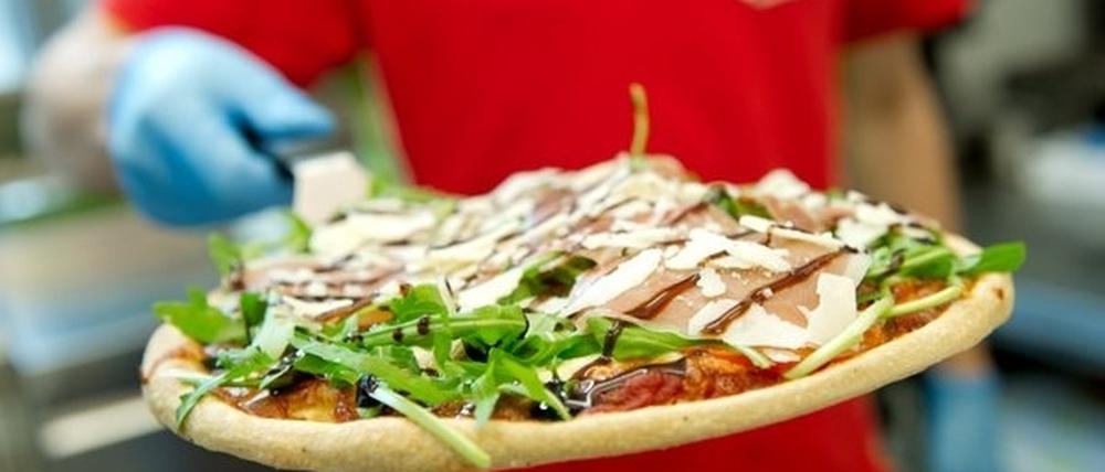 Heiss, knusprig und immer schnell da - doch der Pizza-Service ist skandalös schlecht bezahlt.