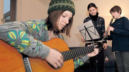 Unterricht nach Noten. Jessica Menthel (M.), Instrumentalpädagogin für Saxophon, Flöte und Klavier an der Freien Musikschule, mit Laura (vorn) und Miro.
