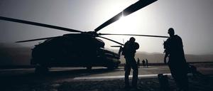 Wie lange noch im Krisengebiet? Soldaten der Bundeswehr stehen in Faisabad in Afghanistan vor einem Hubschrauber. Im Einsatzführungskommando in Geltow soll jetzt der Teilabzug aus Afghanistan koordiniert werden. Die Beelitzer Logistiker sind daran ebenfalls beteiligt.