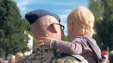 Noch einmal auf Papas Arm: Die Trennung über Monate ist eine der größten Belastungen für die Soldaten – und für ihre Familien.