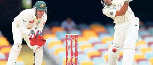Cricket. Der Schläger beschützt die hinter ihm stehenden Stäbe.