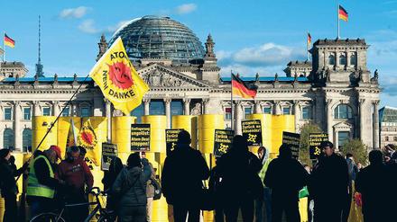 Protest in Schwarz-Gelb. Aus Protest gegen die Atompolitik der Bundesregierung haben Kernkraftgegner am Montag rund 70 Attrappen von Atommüllfässern vor dem Reichstag aufgetürmt. Die Fässer waren tags zuvor in Gorleben auf Lastwagen verladen worden.