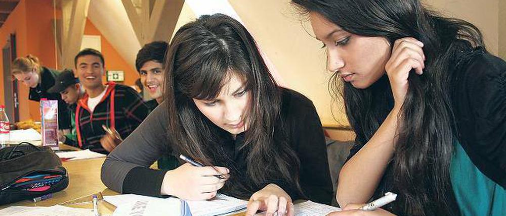 Bildungsferne Migranten? Von wegen! Die beiden Schülerinnen Saryeda (r.) und Farhat büffeln in der studentischen Hausaufgabenhilfe des Kuze. Die Studenten helfen bei englischen Aufsätzen oder höherer Mathematik.