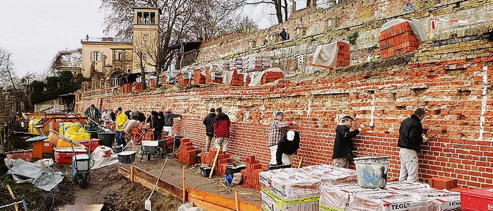 Ein Stein, ein Kalk ... Mit geballter Unterstützung der Potsdamer Bauinnung wurde gestern die erste Terrassenmauer am Winzerberg fertiggestellt. Die Verbliebenen sollen bis 2014 ebenfalls saniert sein.