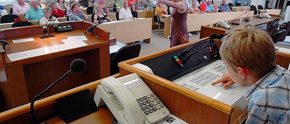 Freiwillige Fingerabdrücke lieferten Besucher wie Nele Besch (o.) beim Tag der Offenen Tür von Landesregierung und Landtag bei der Polizei ab. Beliebtester Raum auf dem Brauhausberg war der Plenarsaal, der einzige mit einer Klimaanlage (l.u.). Bildungsminister Holger Rupprecht testete den neuen Tragschrauber (M.u.), während Ex-Justiz-Minister Hans-Otto Bräutigam über die Wende redete.