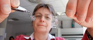 Hightech aus Brandenburg. Mit den Intraokularlinsen der S&V Technologies AG können am grauen Star erkrankte Tiere wieder sehen. Ingeborg Fromberg, Leiterin der Veterinärmedizin, zeigt Standardlinsen für Hunde und die größeren Linsen für Pferde.