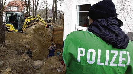 Gartenarbeit. Mit Baggern durchwühlt die Polizei das Grundstück.