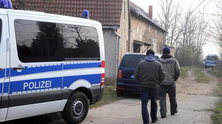 Polizeibeamte gehen in ein Gehöft in Grabow (Potsdam Mittelmark), wo der mutmaßliche Neonazi-Terrorist Andre E. festgenommen wurde. Er wird beschuldigt, in zwei Fällen die rechtsradikale, terroristische Vereinigung NSU unterstützt zu haben. Spezialkräfte der GSG 9 hatten am Donnerstag den 32 Jahre alten Andre E. aus Sachsen hier festgenommen.