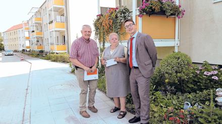 Selbst begrünt. Jutta Rochlitz hat von Hermann Bobka (l.) und Thomas Lück einen Scheck über 100 Euro erhalten. Sie hatte Blumen gekauft und vor dem Wohnblock gepflanzt.